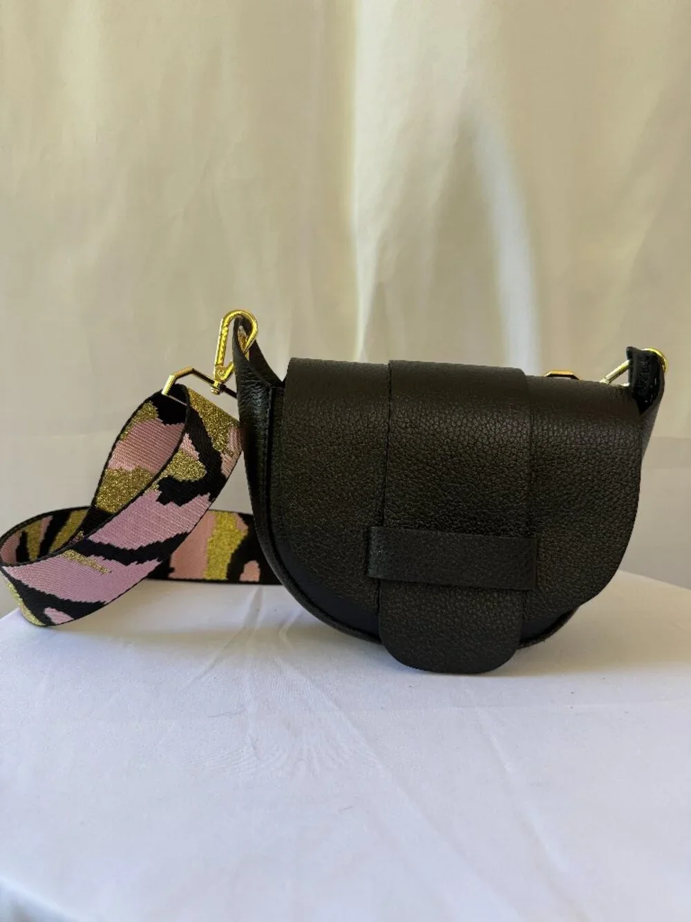 Black purse with pink and black camo strap